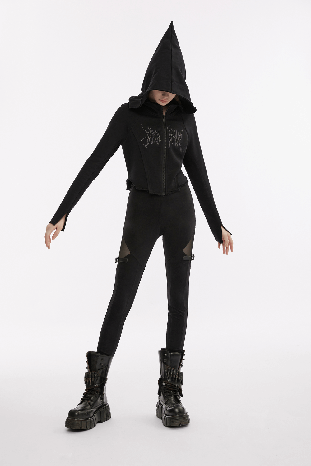Black gothic mesh-panel leggings with buckle accents, paired with a black cropped hoodie and chunky boots.