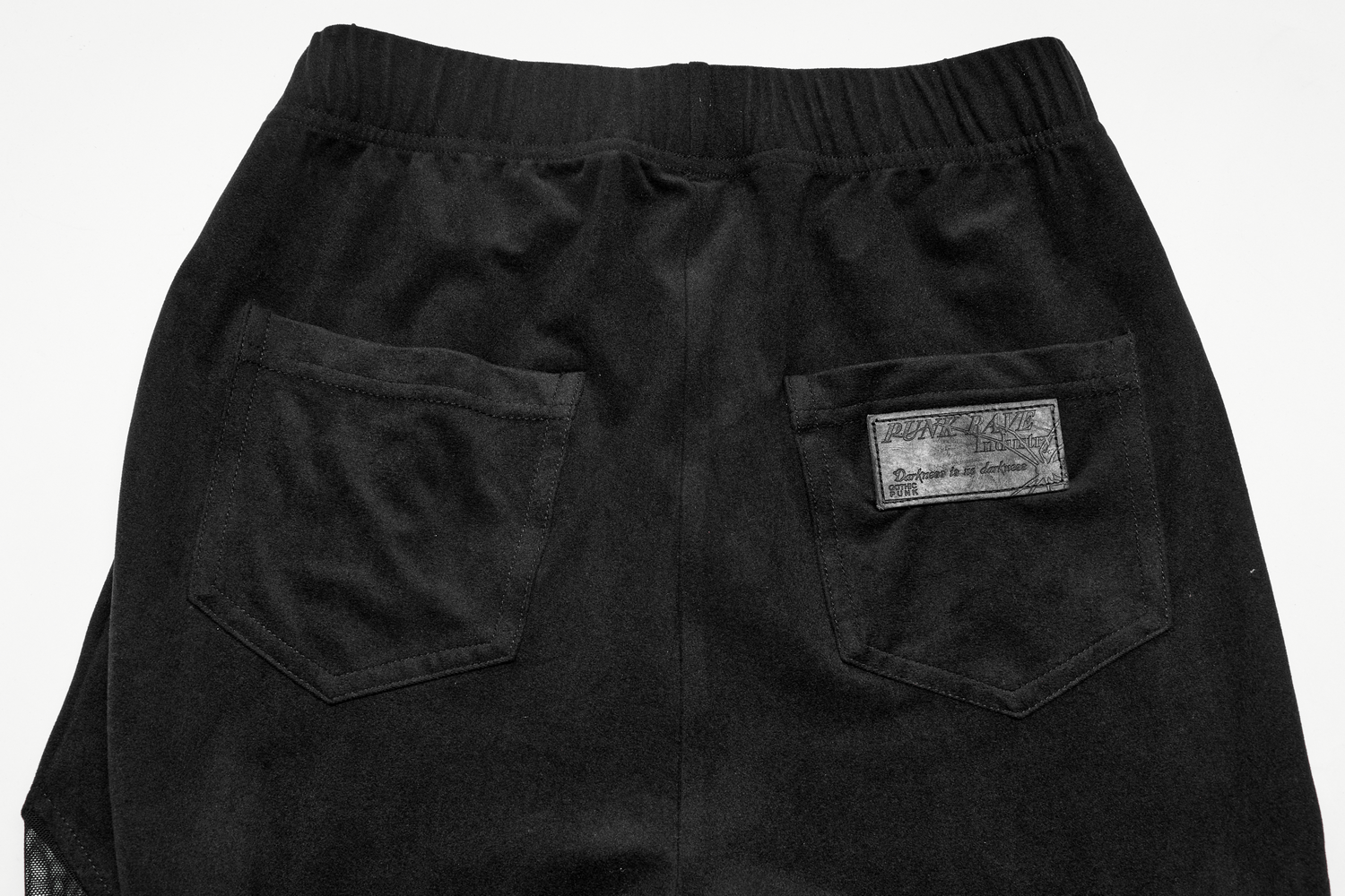 Back view of black gothic leggings with elastic waistband and two rear pockets showcasing punk-inspired design.