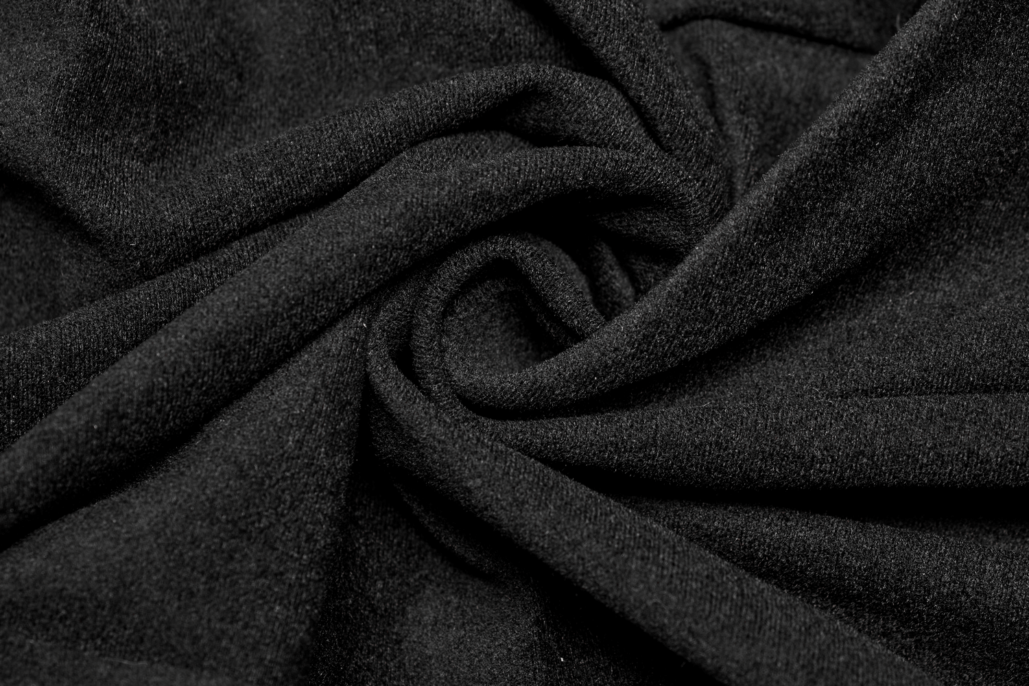Close-up of soft black fabric showcasing a smooth and luxurious texture, ideal for edgy fashion pieces.