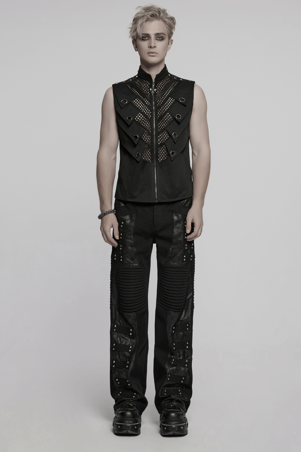 Model wears a black gothic mesh vest with metal eyelet accents, exuding edgy stylishness and bold fashion.