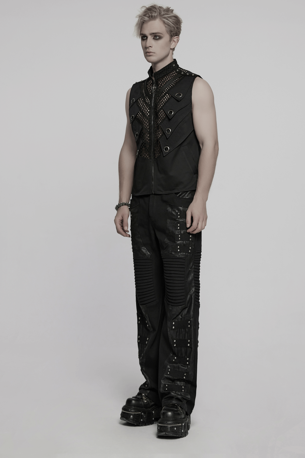 Black gothic mesh vest with metal eyelet accents, showcased on a model, perfect for edgy fashion enthusiasts.