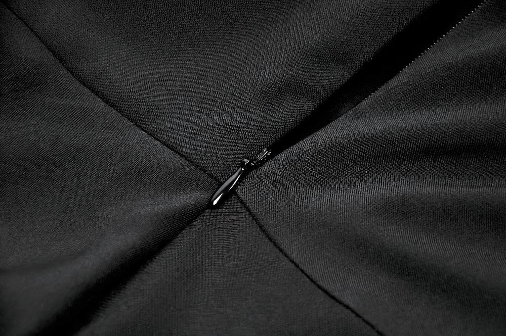 Close-up of the zipper detail on the Black Gothic Mini Dress with Purple Lace Yoke showcasing sleek black fabric.