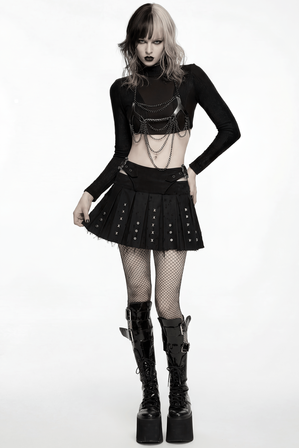 Black Gothic Mini Skirt with Metal Rivet Panels styled with chains and bold boots for a punk look.