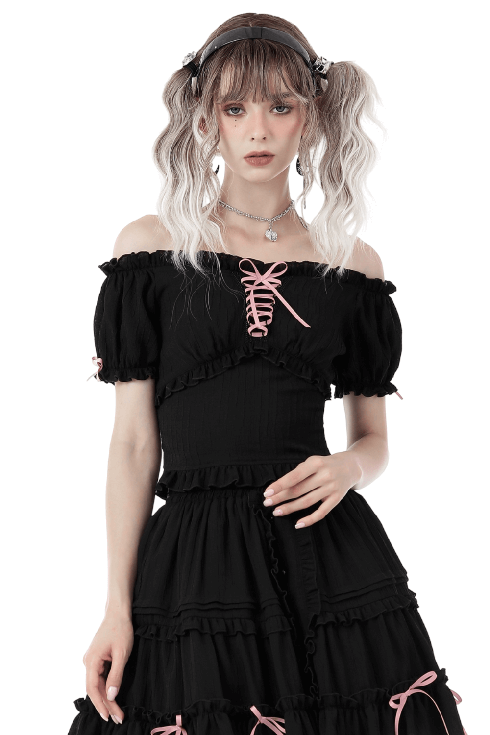Black off-the-shoulder top with pink ribbon accents, perfect for a gothic romantic look.