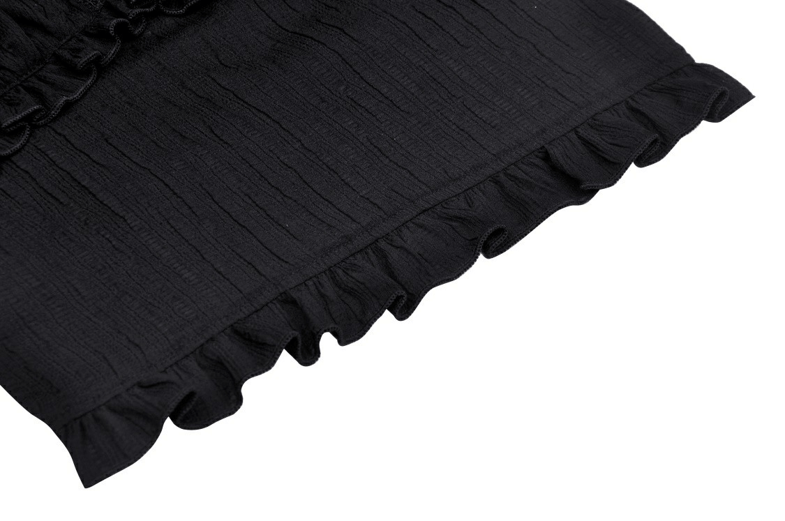 Close-up of textured black fabric with ruffled edge, perfect for a gothic style outfit.
