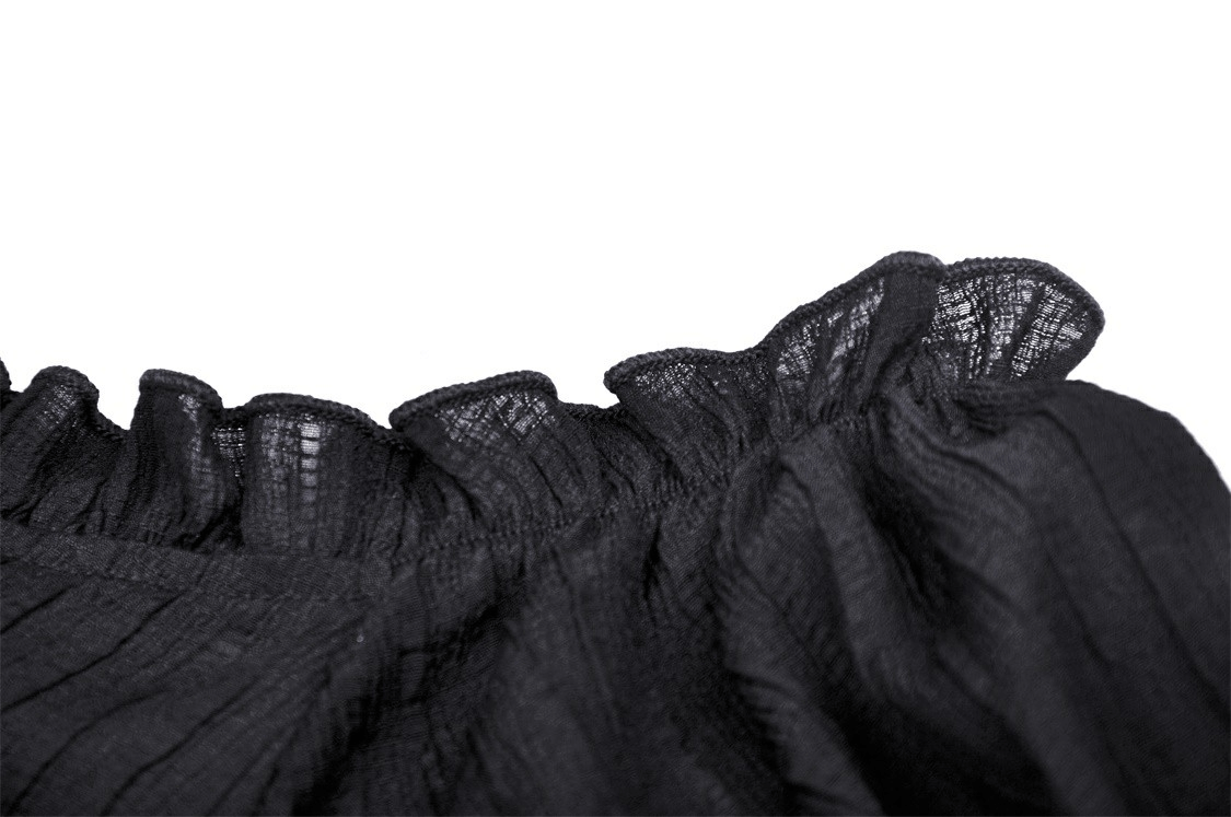 Close-up of black off-the-shoulder top showcasing ruffled neckline with delicate texture and design.