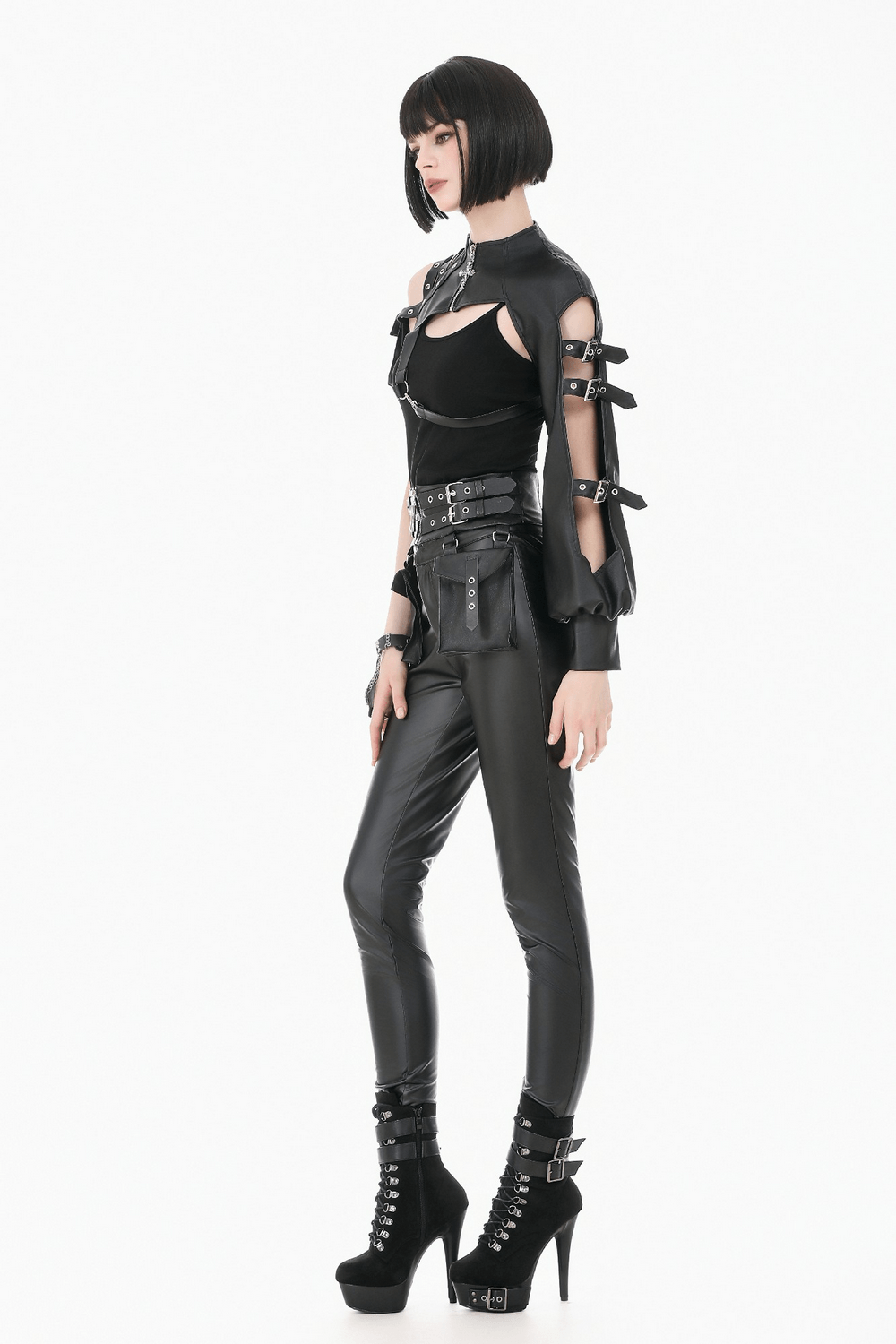 Model wearing a Black Gothic One-Sleeve Bolero with Cross Zip, stylishly paired with faux leather trousers and platform heels.