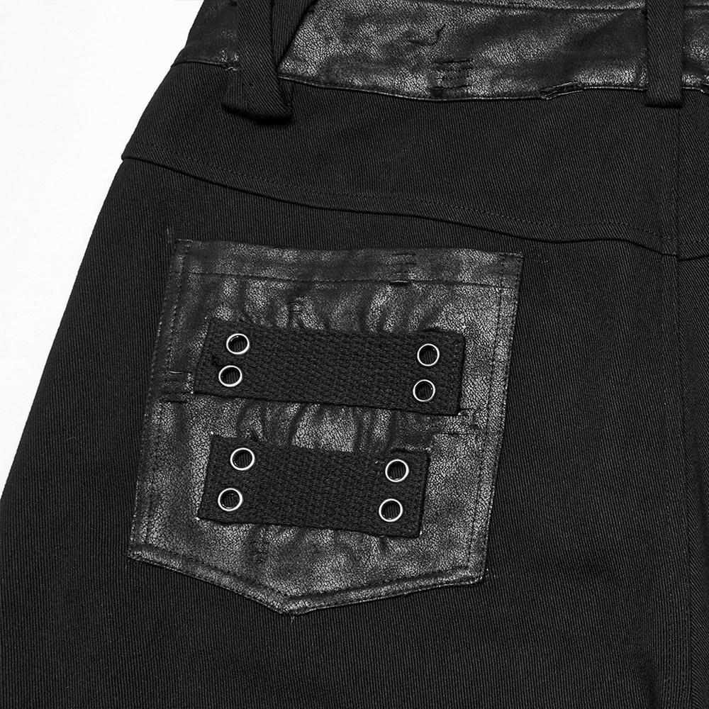 Close-up of black gothic pants with pleated panels and rivets showing unique pocket details and industrial design.