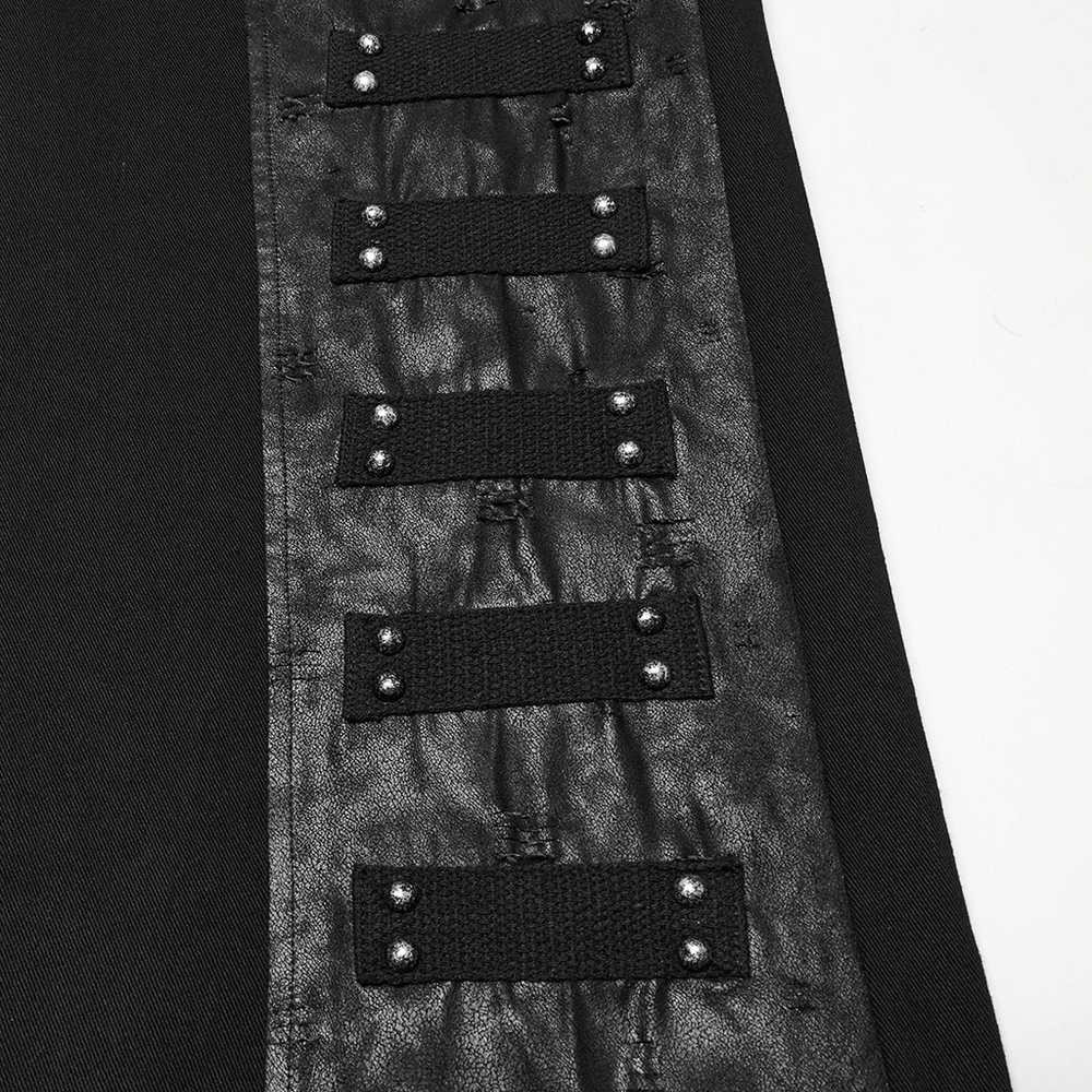 Close-up of black gothic pants featuring riveted panels and woven accents for a punk aesthetic.