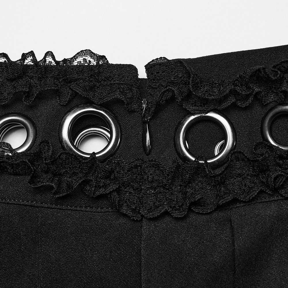 Close-up of black gothic skirt waist with lace and eyelet details, showcasing buckle loop and punk-inspired style.