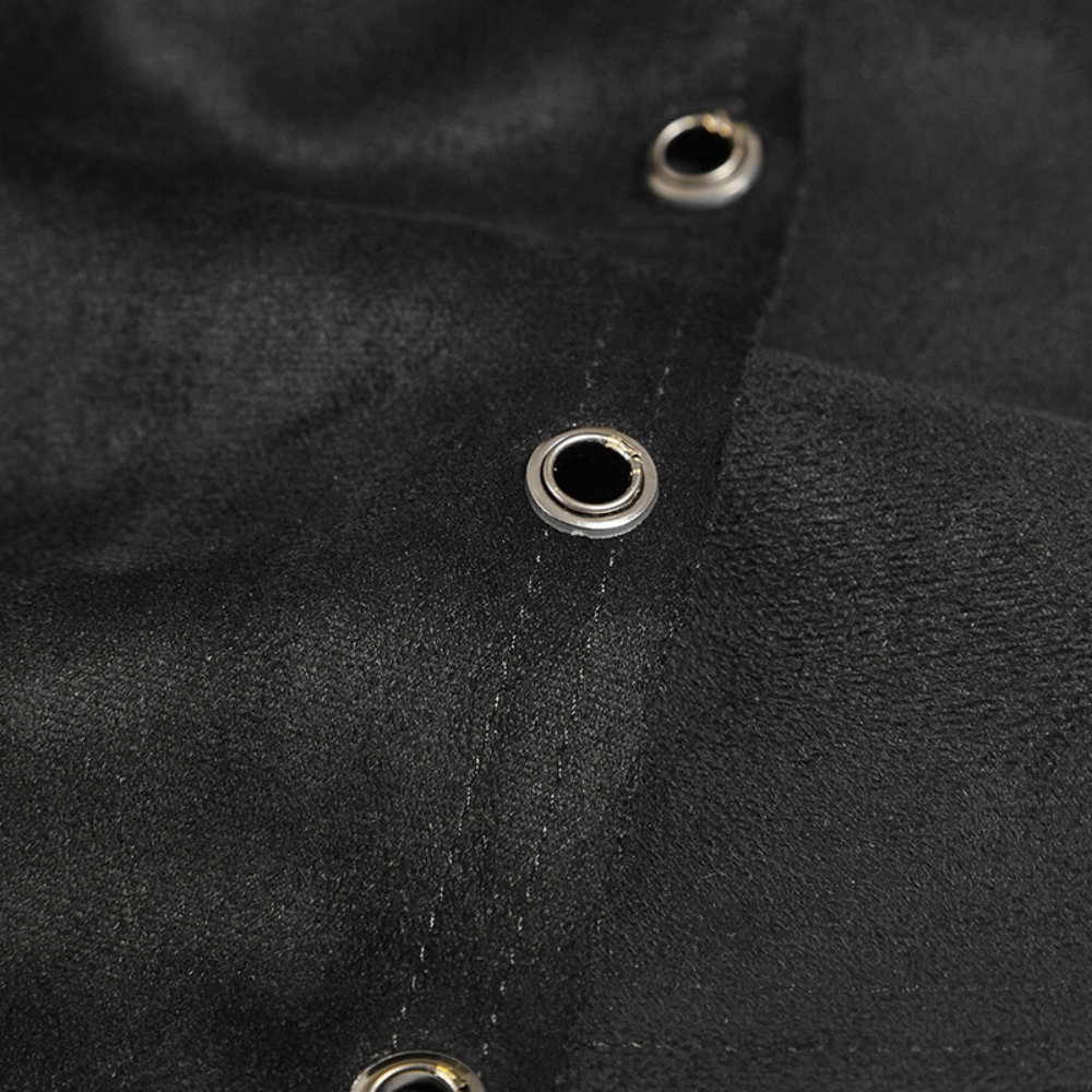 Close-up of black fabric with silver grommets, showcasing punk style and edgy design details.