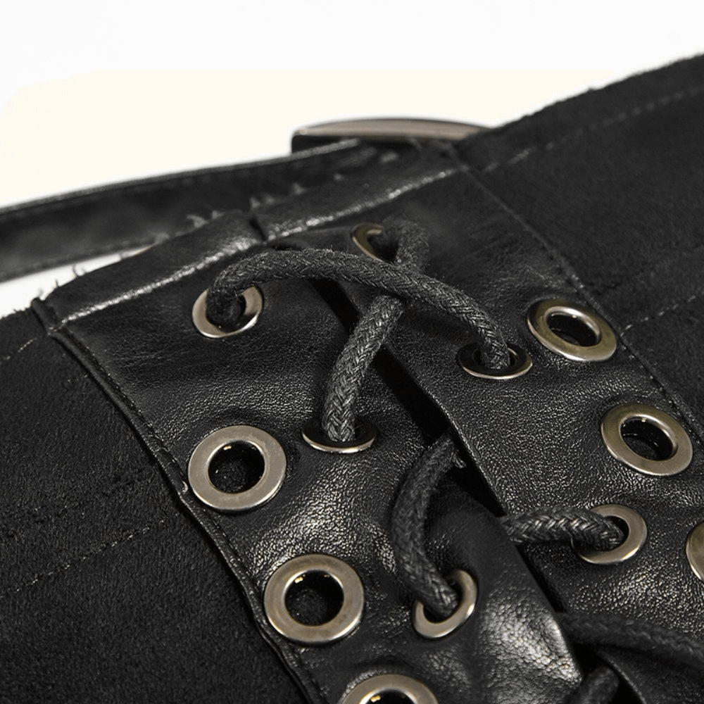 Close-up of black gothic punk skirt detailing with laces and metal grommets.