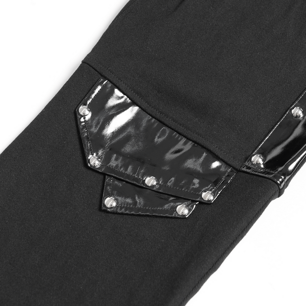 Close-up of black gothic punk pants featuring shiny studded buckle and strap details.