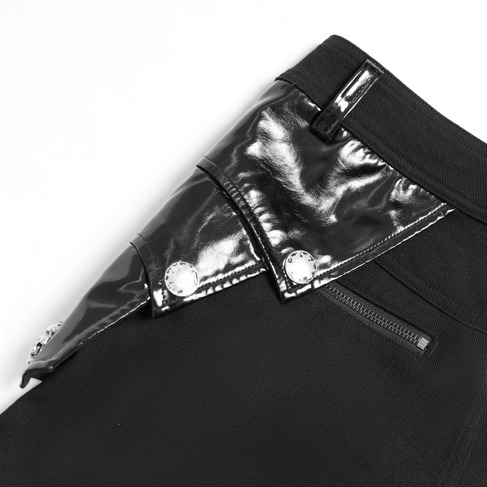 Close-up of black gothic punk pants featuring shiny buckle and strap detail with studs.