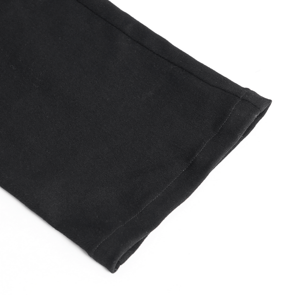 Close-up of the hem of black gothic punk pants featuring sleek stitching and edgy design elements.