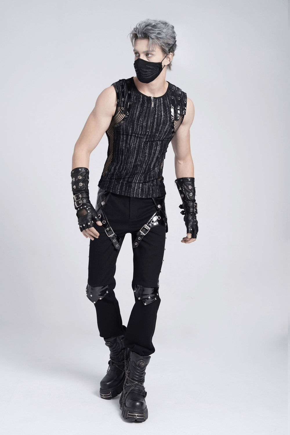 Model wearing black gothic punk pants with studded buckles and straps, showcasing edgy alternative fashion style.