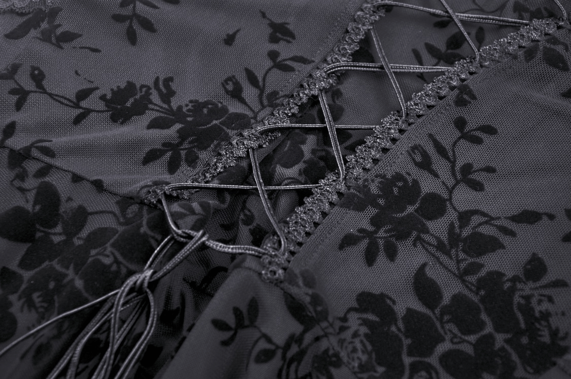 Close-up of black lace detail with floral patterns on a gothic maxi dress, showcasing velveteen and sheer elegance.