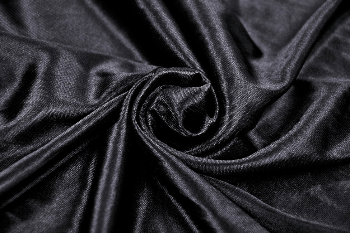Close-up of luxurious black velveteen fabric, perfect for gothic fashion and elegant dresses.