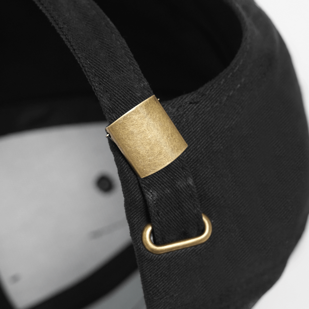 Black Gothic Safety Pin and Chain Baseball Cap adjustable strap detail with brass buckle and black fabric.