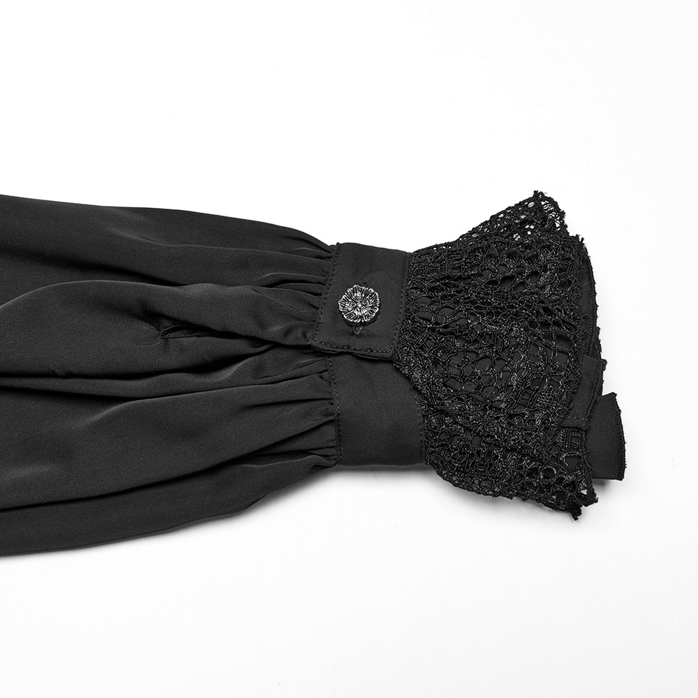Close-up of a black gothic shirt cuff with lace detailing and decorative button, showcasing dark elegance.
