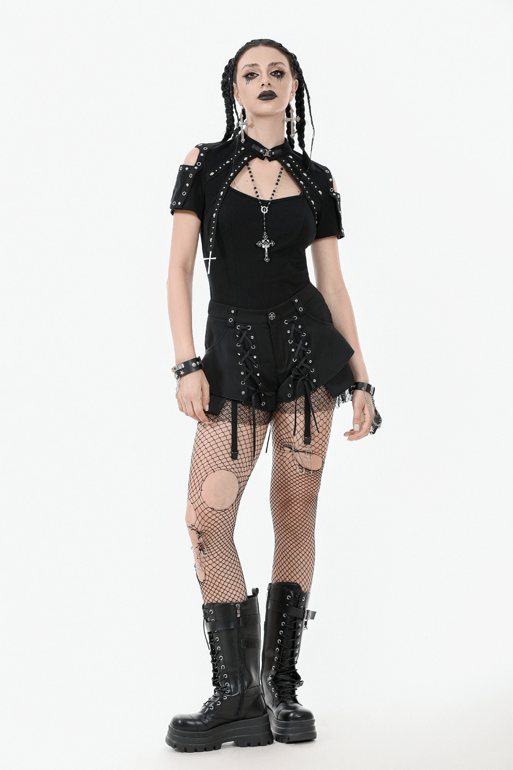 Model showcasing black gothic shorts with straps, mesh accents, and detachable flares for a punk-inspired look.