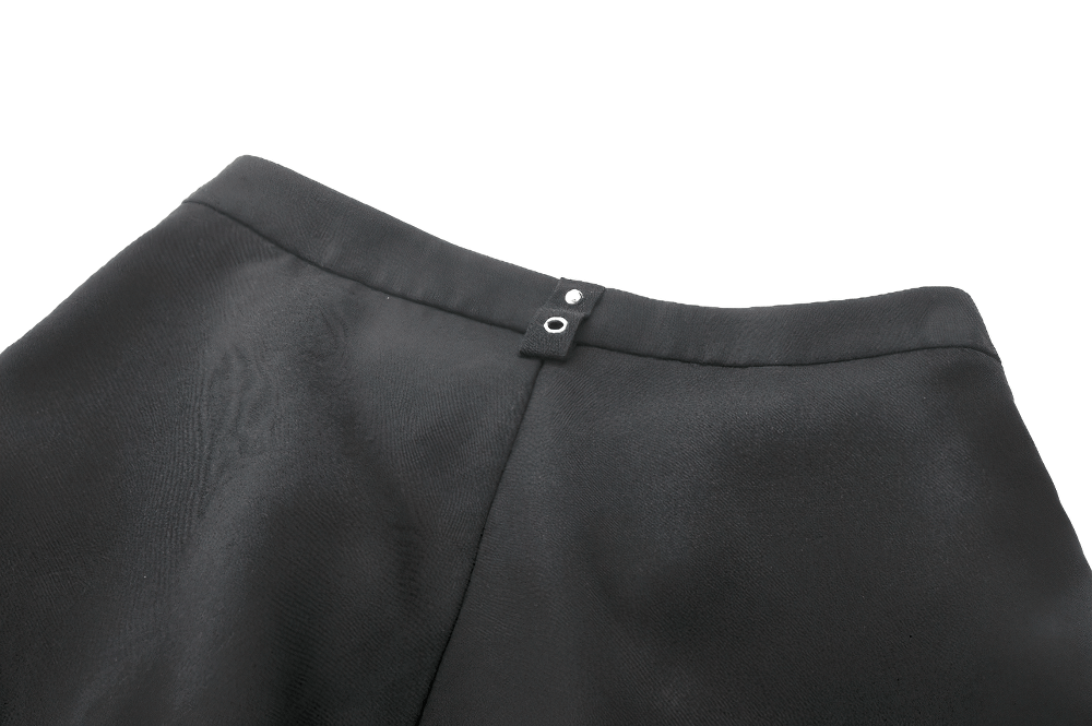 Close-up of the back detail of black gothic shorts showcasing metal button and sleek fabric.