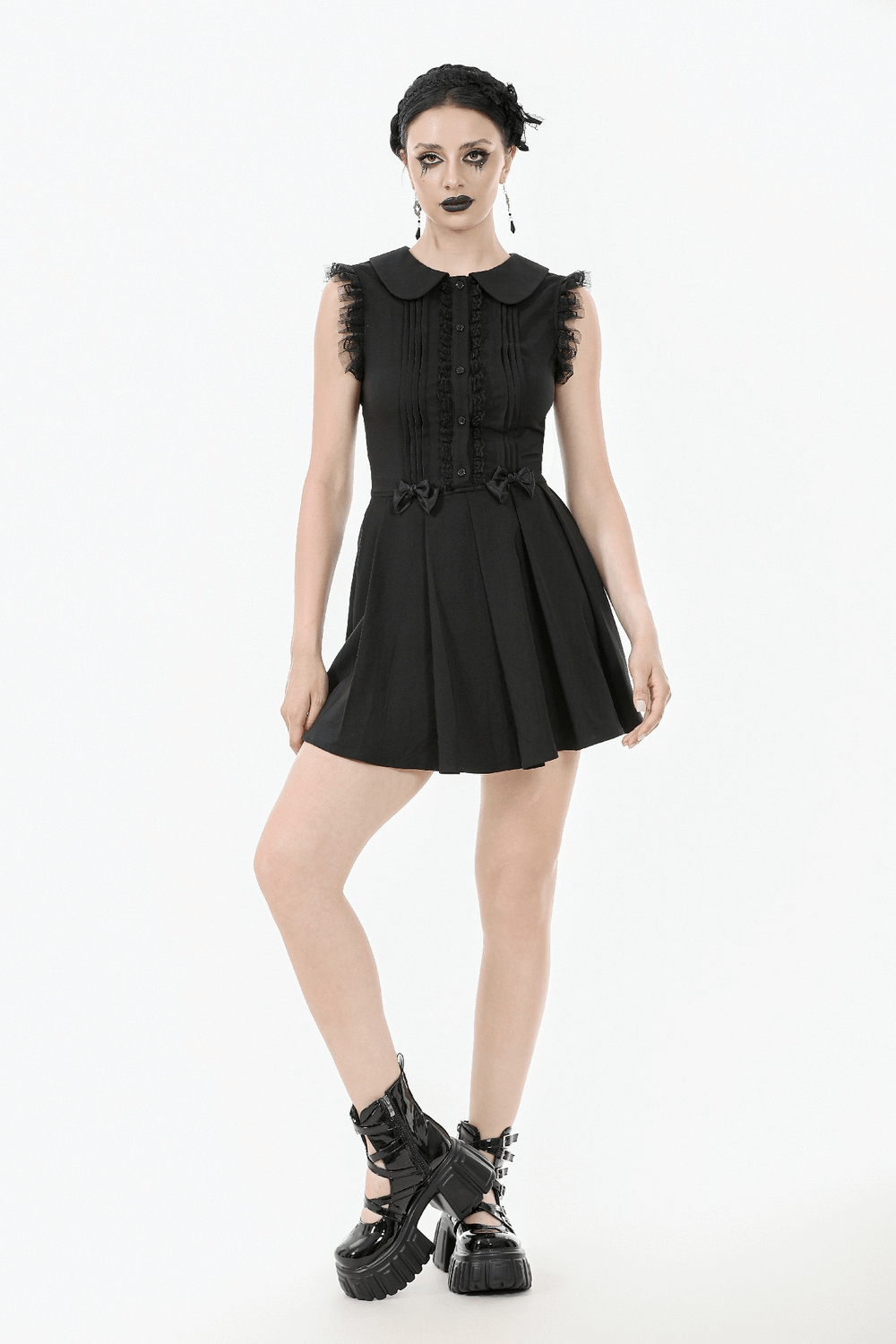 Black gothic sleeveless dress with lace trim, Peter Pan collar, pleats, and satin bows for a punk-inspired look.