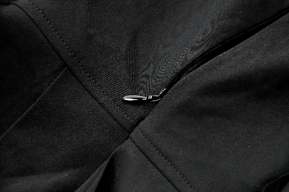 Close-up of a zipper detail on a black fabric, highlighting sleek design and quality craftsmanship.