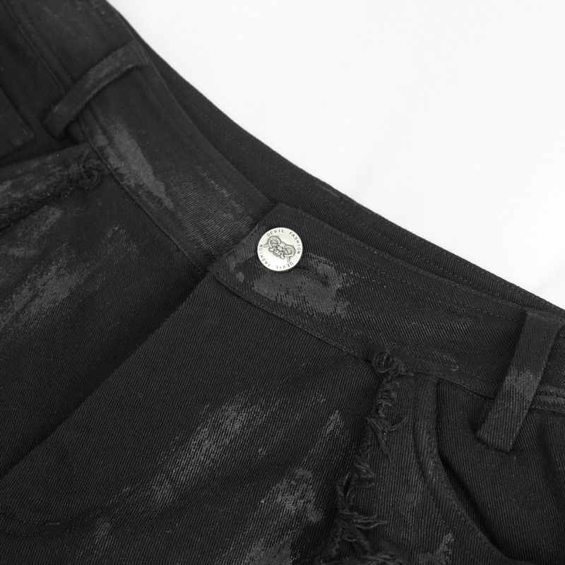 Close-up of black gothic slim-fitted pants showing lace-up detail and ripped knee aesthetic for men.