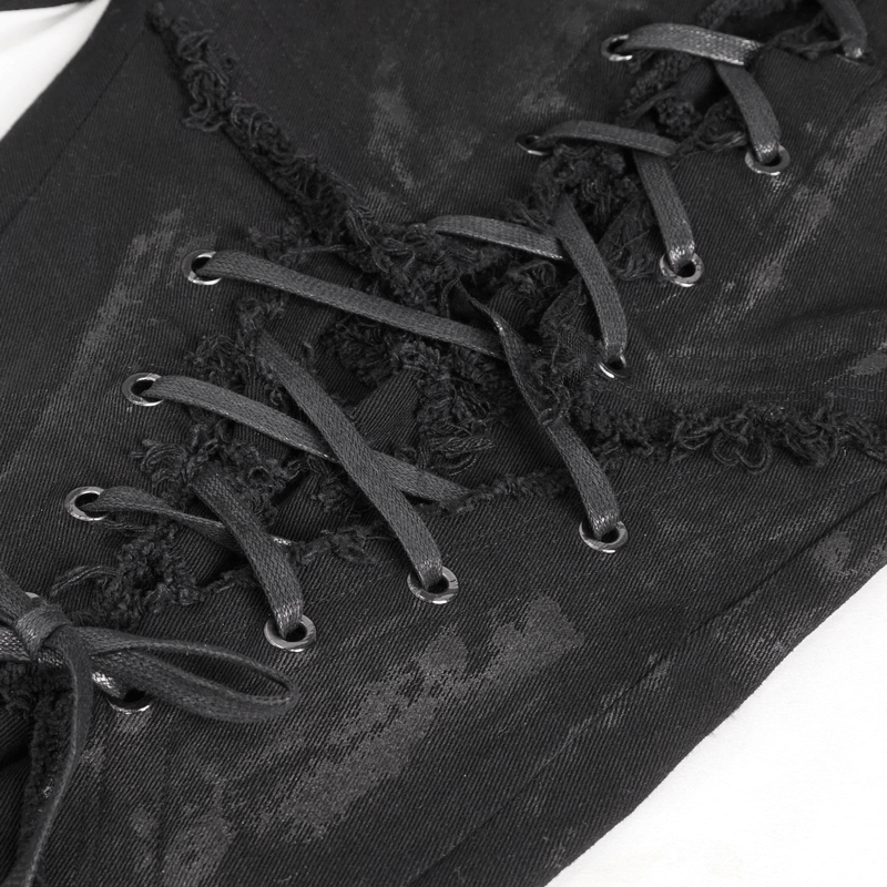Close-up of black gothic slim-fitted pants featuring stylish lace-up detail on the thigh and edgy distressed fabric.
