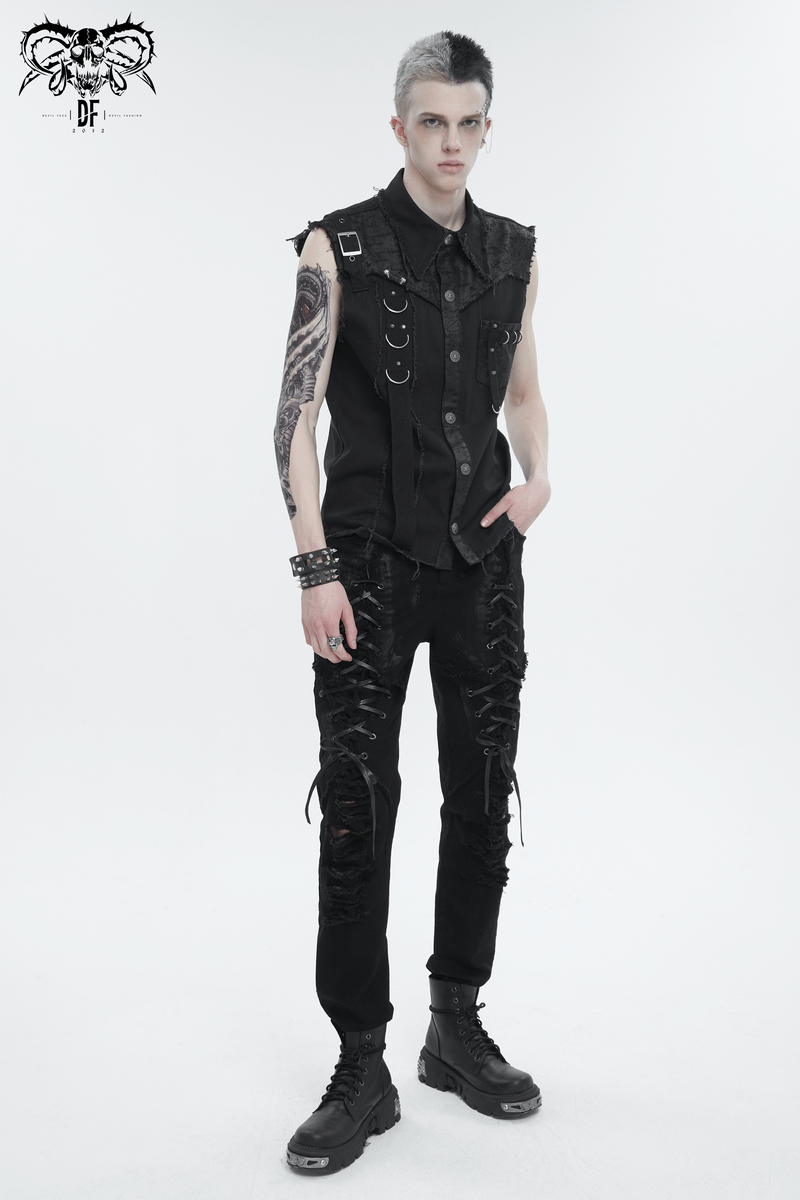 Stylish male model in black gothic slim-fitted pants with lace-up detailing and ripped knees, showcasing edgy fashion.