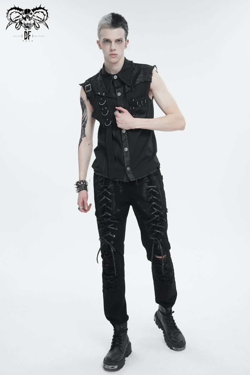 Stylish male model in black gothic slim-fitted pants with lace-up detailing and sleeveless shirt, showcasing edgy fashion.
