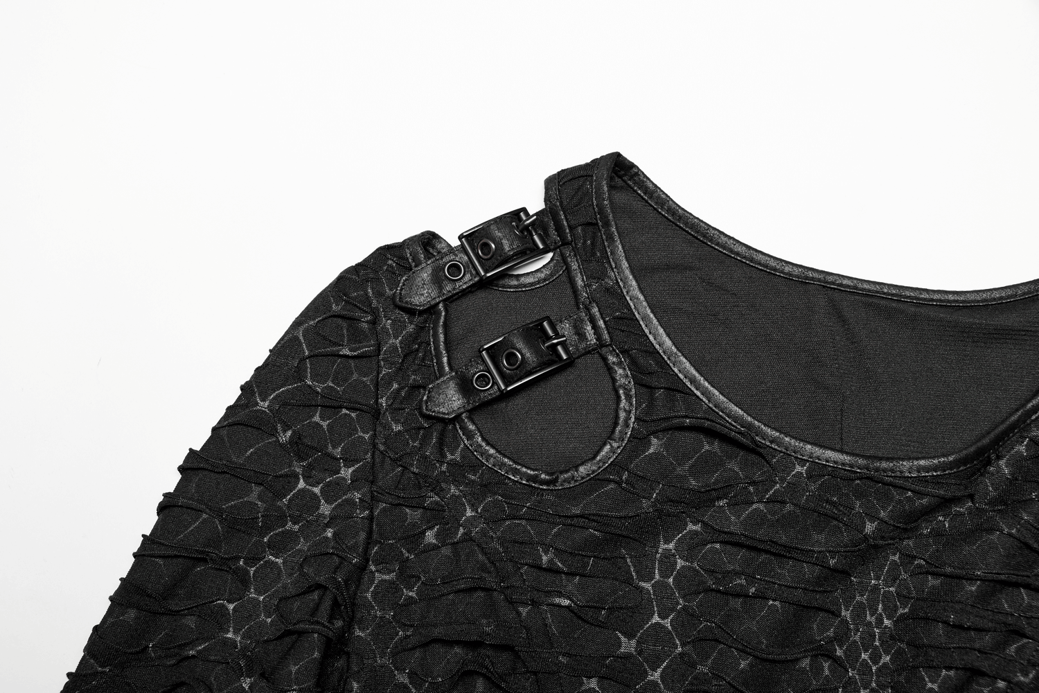 Close-up of black gothic dress showcasing snake print fabric and edgy shoulder cutout with metal buckles.