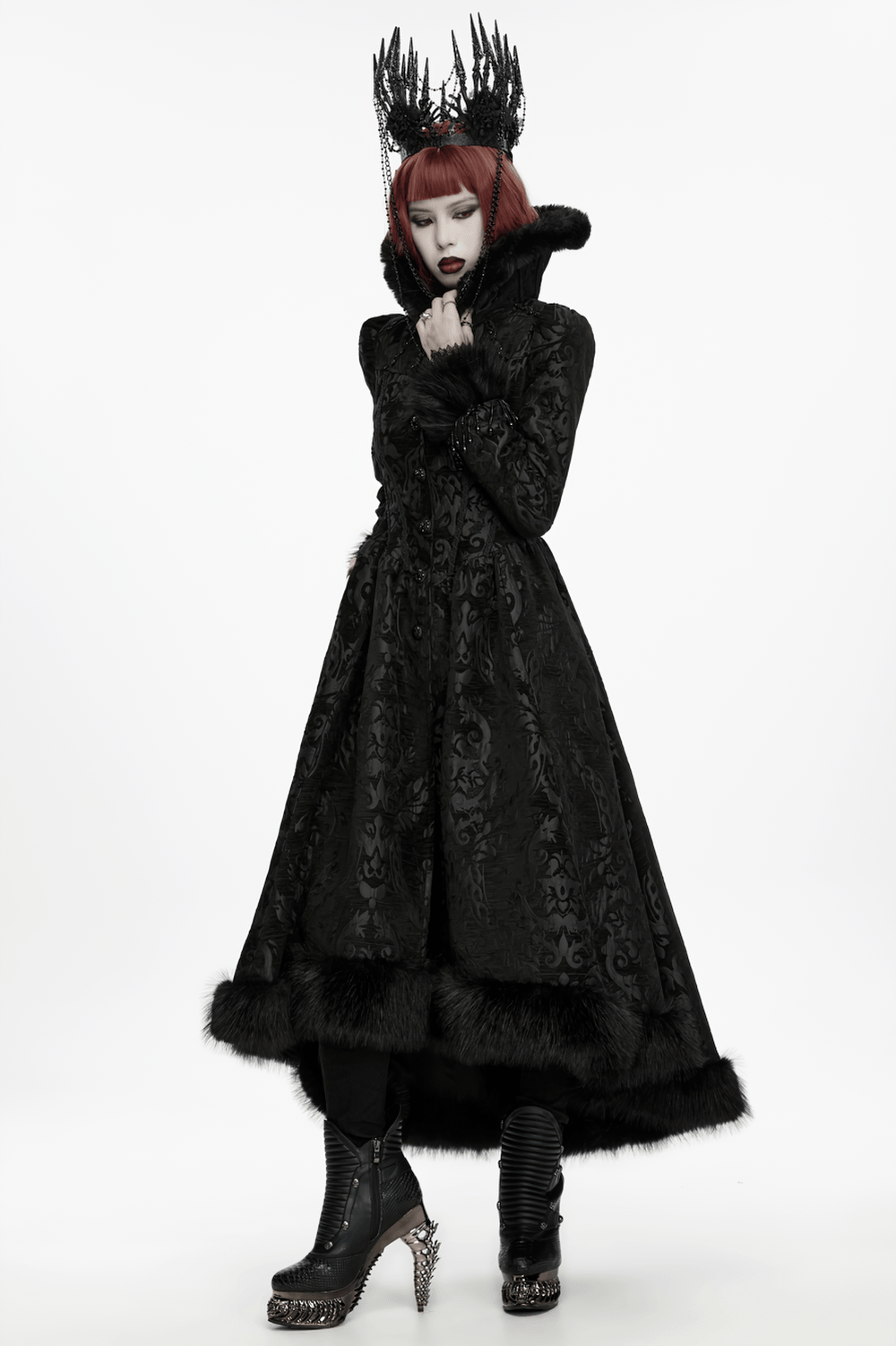 Model wearing Black Gothic Thorn Crown with Chains and Bone Hands, black ornate coat and gothic boots, striking dark style.