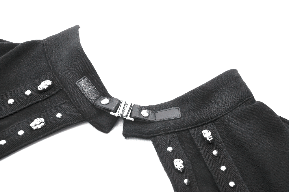 Close-up of a black gothic top featuring studded cross and cut-out design, showcasing intricate detailing and edgy style.