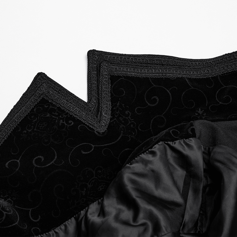 Close-up of the double-layered collar of a black gothic vampire cloak with embossed velvet and decorative trim.