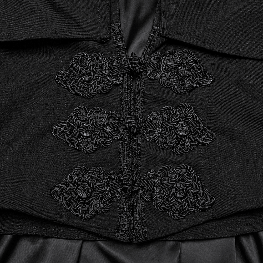 Close-up of black embossed buttons on a Gothic vampire cloak showcasing intricate design and craftsmanship.