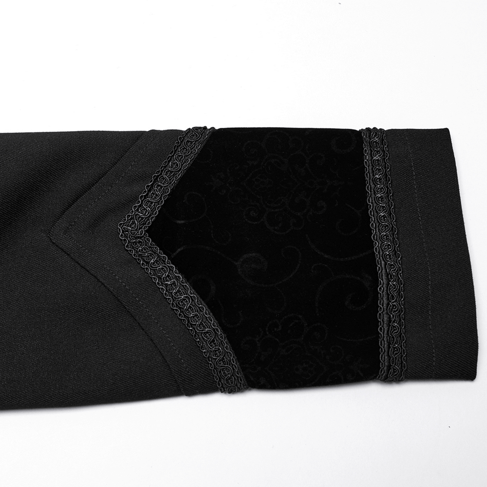 Close-up of the embroidered velvet detail on the sleeve of a black gothic vampire cloak.