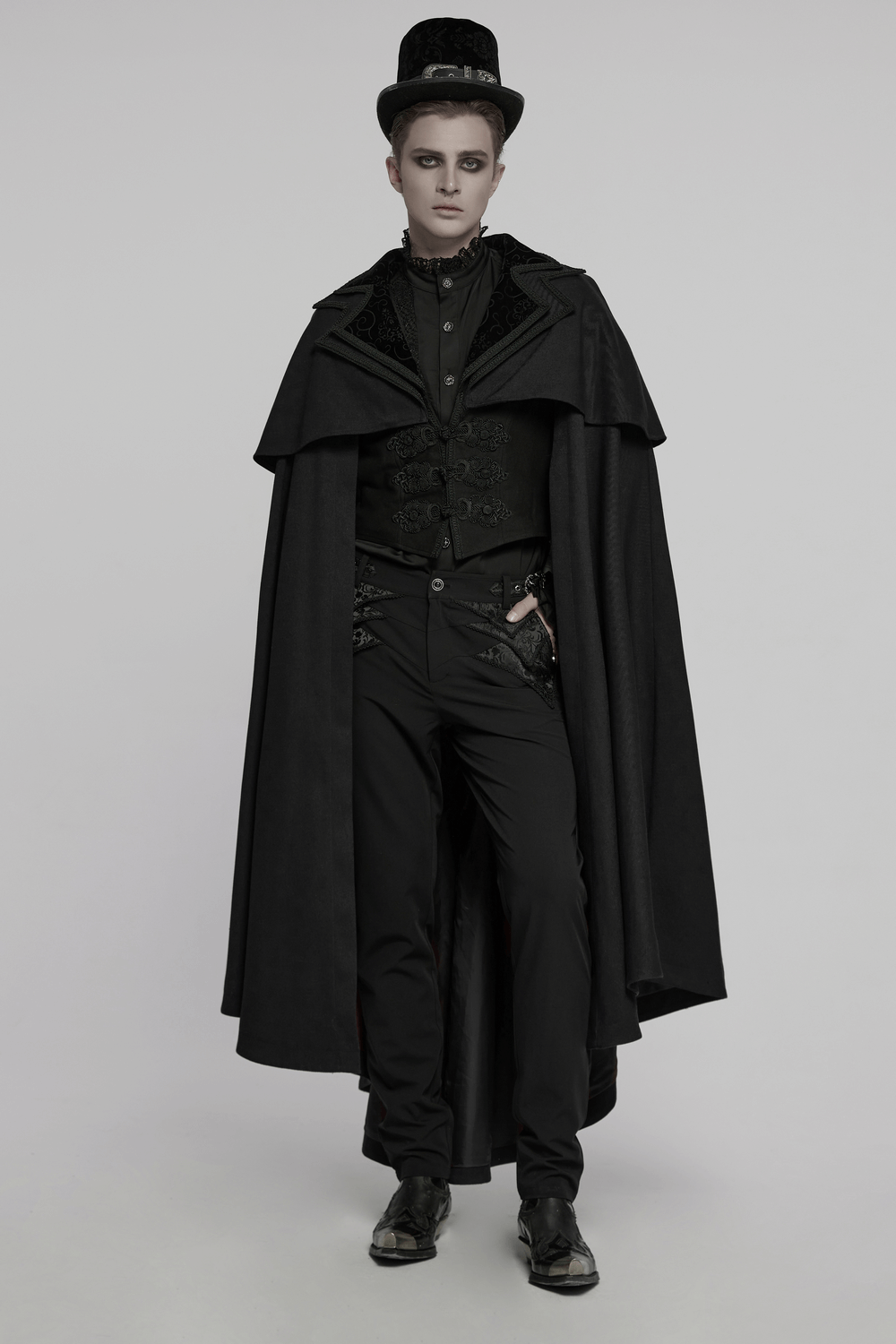 Model showcasing a Black Gothic Vampire Cloak with a double-layered collar and embossed velvet details.