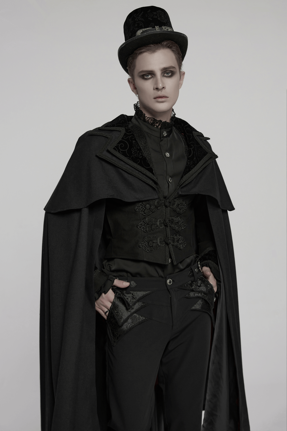 Model wearing a black gothic vampire cloak with double-layered collar and vintage buttons, styled for a dramatic look.