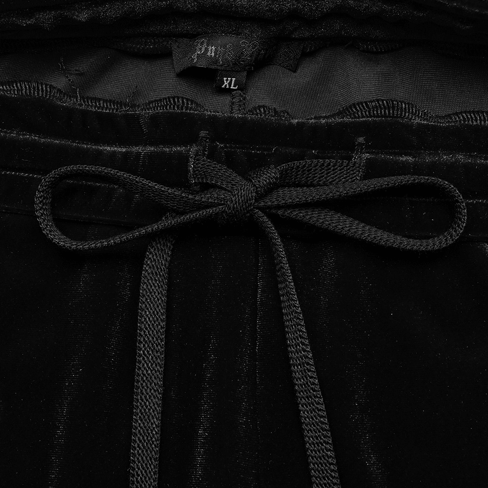Close-up of the waistband and drawstring of black velvet flared pants, showcasing the elegant details and comfort.