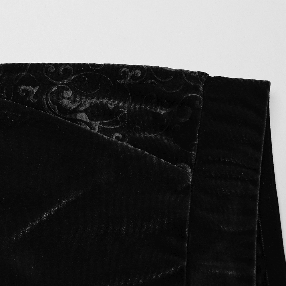 Close-up of embossed detailing on black gothic velvet flared pants, showcasing elegant texture and fabric quality.
