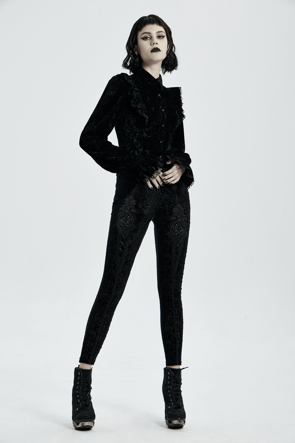 Black gothic velvet leggings with floral lace detail, paired with a stylish black blouse and gothic-inspired heels.