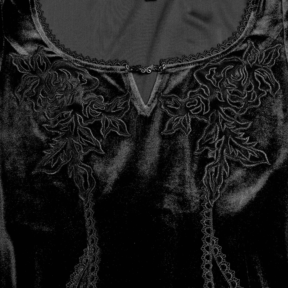 Close-up of black gothic velvet dress featuring elegant rose embroidery and lace detailing on the neckline.