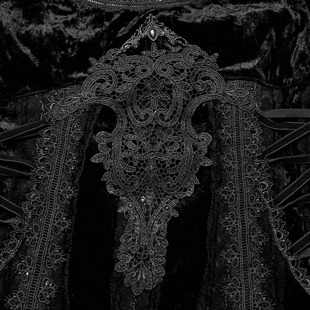 Close-up of intricate retro lace design on a black gothic velvet dress, featuring elegant metal decorations.