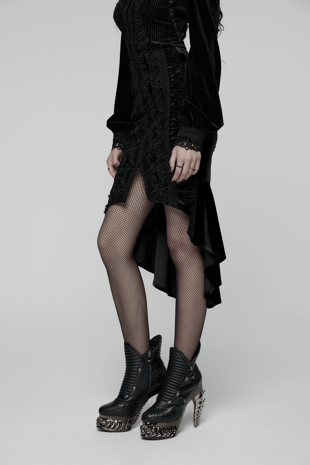 Black Gothic Velvet Rose Lace High-Low Fishtail Skirt styled with fishnet stockings and edgy boots.