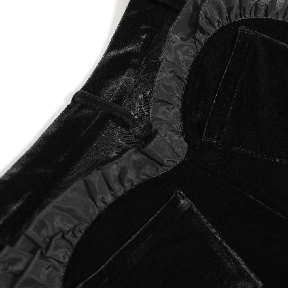 Close-up of the fabric and details of Black Gothic Velvet Shorts With Floral Ruffle Trim.