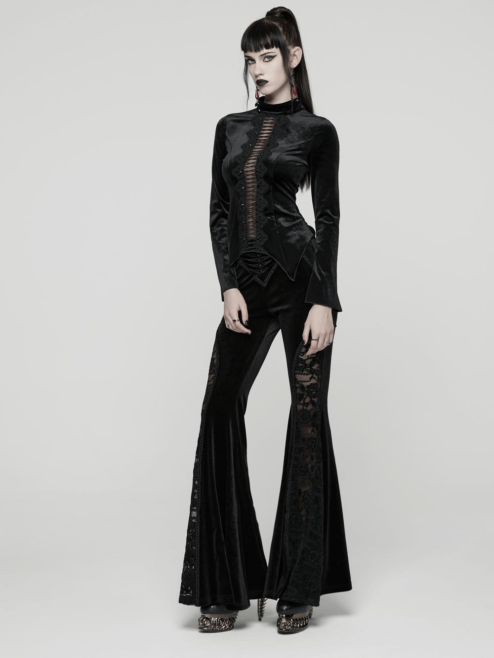 Black Gothic Velvet Top with Lace and Stud Details worn with stylish gothic pants, showcasing elegant couture and dark style.