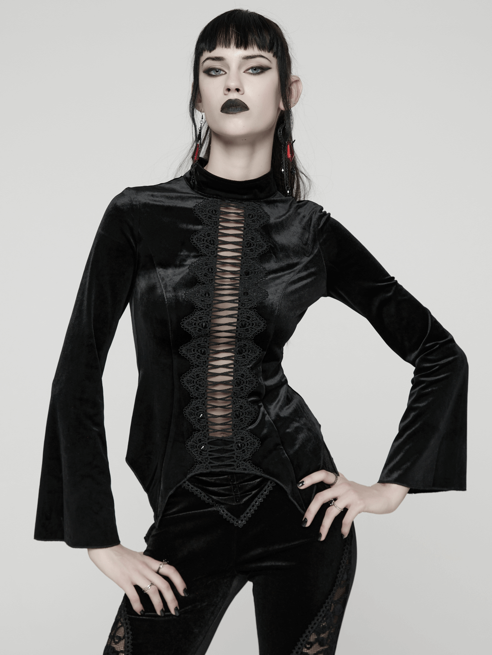 Black Gothic Velvet Top with Lace and Stud Details worn by model, featuring stand collar and hollow lace design.