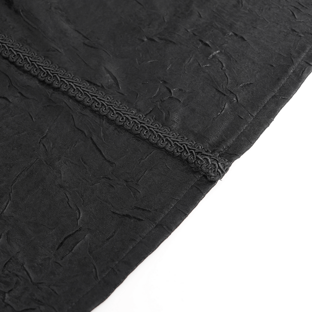 Close-up of textured black fabric showcasing intricate details and lace trim for a gothic Victorian shirt.